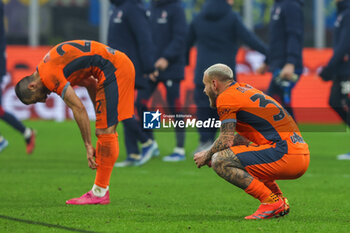 2023-12-20 - Federico Dimarco of FC Internazionale and Henrikh Mkhitaryan of FC Internazionale react at the end of the match during Coppa Italia 2023/24 Round of 16 football match between FC Internazionale and Bologna FC at Giuseppe Meazza Stadium, Milan, Italy on December 21, 2023 - INTER - FC INTERNAZIONALE VS BOLOGNA FC - ITALIAN CUP - SOCCER