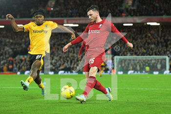 2023-01-07 - Liverpool defender Andrew Robertson (26) crosses the ball in front of Wolverhampton Wanderers Dexter Lembikisa (81) during the English FA Cup, 3rd round football match between Liverpool and Wolverhampton Wanderers on January 7, 2023 at Anfield stadium in Liverpool, England - FOOTBALL - ENGLISH CUP - LIVERPOOL V WOLVERHAMPTON - ENGLISH LEAGUE CUP - SOCCER
