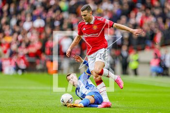 2023-04-24 - Solly March (7) of Brighton & Hove Albion slides in and attempts to tackle Diogo Dalot (20) of Manchester United during the English championship, FA Cup semi final football match between Brighton and Hove Albion and Manchester United on 23 April 2023 at Wembley Stadium in London, England - FOOTBALL - ENGLISH CUP - BRIGHTON V MANCHESTER UNITED - ENGLISH LEAGUE CUP - SOCCER