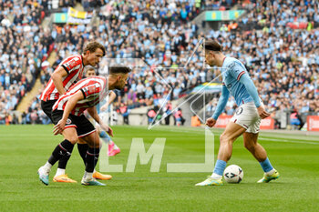 2023-04-24 - Jack Grealish (10) of Manchester City is challenged by Sander Berge (8) and George Baldock (2) of Sheffield United during the English Cup, FA Cup semi final football match between Manchester City and Sheffield United on 22 April 2023 at Wembley Stadium in London, England - FOOTBALL - ENGLISH CUP - MANCHESTER CITY V SHEFFIELD UNITED - ENGLISH LEAGUE CUP - SOCCER
