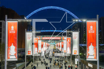 2023-04-24 - General view outside Wembley Stadium at dusk looking along Olympic Way to the stadium with Emirates FA Cup branding after the English Cup, FA Cup semi final football match between Manchester City and Sheffield United on 22 April 2023 at Wembley Stadium in London, England - FOOTBALL - ENGLISH CUP - MANCHESTER CITY V SHEFFIELD UNITED - ENGLISH LEAGUE CUP - SOCCER