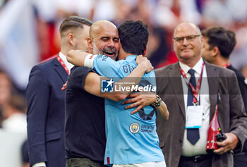 2023-06-04 - Pep Guardiola Manager of Manchester City hugs İlkay Gundogan (8) of Manchester City at full time during the English FA Cup, Final football match between Manchester City and Manchester United on 3 June 2023 at Wembley Stadium in London, England - FOOTBALL - ENGLISH CUP - FINAL - MANCHESTER CITY V MANCHESTER UNITED - ENGLISH LEAGUE CUP - SOCCER