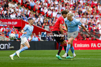 2023-06-04 - Erling Haaland (9) of Manchester City shoots during the English FA Cup, Final football match between Manchester City and Manchester United on 3 June 2023 at Wembley Stadium in London, England - FOOTBALL - ENGLISH CUP - FINAL - MANCHESTER CITY V MANCHESTER UNITED - ENGLISH LEAGUE CUP - SOCCER