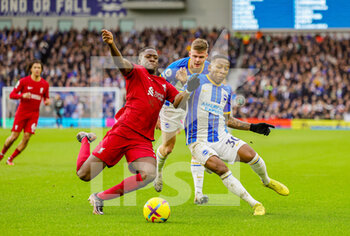 2023-01-14 - Ibrahima Konate (5) of Liverpool slides in and tackles Pervis Estupinan (30) of Brighton & Hove Albion during the English championship Premier League football match between Brighton and Hove Albion and Liverpool on January 14, 2023 at the American Express Community Stadium in Brighton and Hove, England - FOOTBALL - ENGLISH CHAMP - BRIGHTON V LIVERPOOL - ENGLISH PREMIER LEAGUE - SOCCER