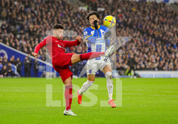2023-01-14 - Alex Oxlade-Chamberlain (15) of Liverpool, Kaoru Mitoma (22) of Brighton & Hove Albion during the English championship Premier League football match between Brighton and Hove Albion and Liverpool on January 14, 2023 at the American Express Community Stadium in Brighton and Hove, England - FOOTBALL - ENGLISH CHAMP - BRIGHTON V LIVERPOOL - ENGLISH PREMIER LEAGUE - SOCCER
