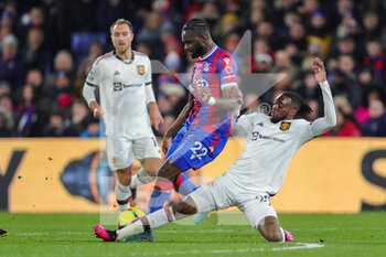 2023-01-19 - Crystal Palace Odsonne Edouard tackled by Manchester United defender Aaron Wan-Bissaka during the English championship Premier League football match between Crystal Palace and Manchester United on January 18, 2023 at Selhurst Park in London, England - FOOTBALL - ENGLISH CHAMP - CRYSTAL PALACE V MANCHESTER UNITED - ENGLISH PREMIER LEAGUE - SOCCER
