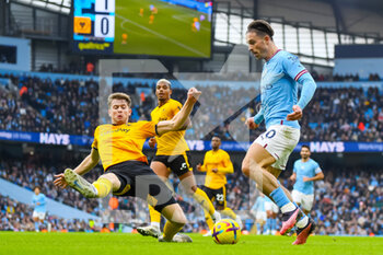 2023-01-22 - Wolverhampton Wanderers defender Nathan Collins (4) makes a tackle on Manchester City midfielder Jack Grealish during the English championship Premier League football match between Manchester City and Wolverhampton Wanderers on January 22, 2023 at the Etihad Stadium in Manchester, England - FOOTBALL - ENGLISH CHAMP - MANCHESTER CITY V WOLVERHAMPTON - ENGLISH PREMIER LEAGUE - SOCCER