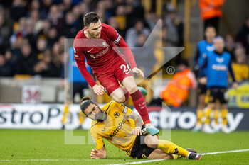 2023-02-04 - Liverpool defender Andrew Robertson (26) jumps over Wolverhampton Wanderers midfielder Ruben Neves (8) during the English championship Premier League football match between Wolverhampton Wanderers and Liverpool on February 4, 2023 at Molineux stadium in Wolverhampton, England - FOOTBALL - ENGLISH CHAMP - WOLVERHAMPTON V LIVERPOOL - ENGLISH PREMIER LEAGUE - SOCCER