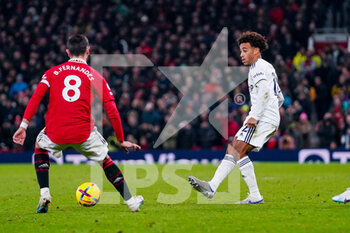 2023-02-08 - Leeds United midfielder Tyler Adams (12) and Bruno Fernandes of Manchester United during the English championship Premier League football match between Manchester United and Leeds United on February 8, 2023 at Old Trafford in Manchester, England - FOOTBALL - ENGLISH CHAMP - MANCHESTER UNITED V LEEDS - ENGLISH PREMIER LEAGUE - SOCCER