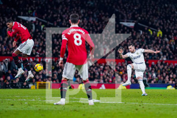 2023-02-08 - Leeds United midfielder Jack Harrison (11) takes a shot, Marcus Rashford of Manchester United during the English championship Premier League football match between Manchester United and Leeds United on February 8, 2023 at Old Trafford in Manchester, England - FOOTBALL - ENGLISH CHAMP - MANCHESTER UNITED V LEEDS - ENGLISH PREMIER LEAGUE - SOCCER