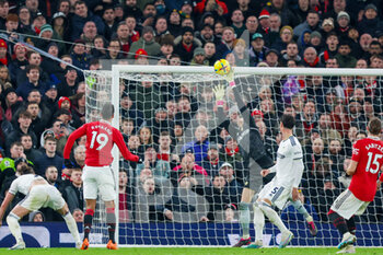 2023-02-08 - Manchester United defender Raphael Varane (19) header is saved by Leeds United goalkeeper Illan Meslier (1) during the English championship Premier League football match between Manchester United and Leeds United on February 8, 2023 at Old Trafford in Manchester, England - FOOTBALL - ENGLISH CHAMP - MANCHESTER UNITED V LEEDS - ENGLISH PREMIER LEAGUE - SOCCER
