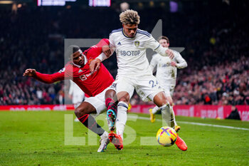 2023-02-08 - Leeds United forward Georginio Rutter (24) wrestles with Manchester United defender Tyrell Malacia (12) during the English championship Premier League football match between Manchester United and Leeds United on February 8, 2023 at Old Trafford in Manchester, England - FOOTBALL - ENGLISH CHAMP - MANCHESTER UNITED V LEEDS - ENGLISH PREMIER LEAGUE - SOCCER