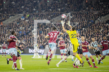 2023-04-05 - Newcastle United goalkeeper Nick Pope (22) saves the ball, Nayef Aguerd of West Ham during the English championship Premier League football match between West Ham United and Newcastle United on 5 April 2023 at the London Stadium in London, England - FOOTBALL - ENGLISH CHAMP - WEST HAM V NEWCASTLE - ENGLISH PREMIER LEAGUE - SOCCER