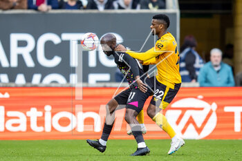 2023-04-15 - Brentford forward Yoane Wissa (11) battles for possession with Brentford goalkeeper Thomas Strakosha (22) during the English championship Premier League football match between Wolverhampton Wanderers and Brentford on 15 April 2023 at Molineux stadium in Wolverhampton, England - FOOTBALL - ENGLISH CHAMP - WOLVERHAMPTON V BRENTFORD - ENGLISH PREMIER LEAGUE - SOCCER