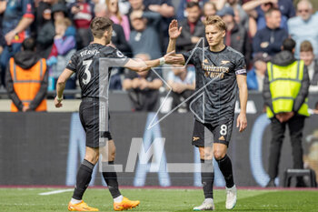 2023-04-16 - Arsenal midfielder Martin Odegaard (8) celebrates his goal 0-2 with Kieran Tierney during the English championship Premier League football match between West Ham United and Arsenal on 16 April 2023 at the London Stadium in London, England - FOOTBALL - ENGLISH CHAMP - WEST HAM V ARSENAL - ENGLISH PREMIER LEAGUE - SOCCER