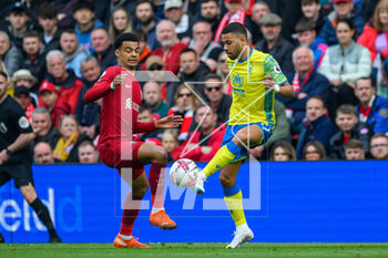2023-04-22 - Renan Lodi of Nottingham Forest and Cody Gakpo of Liverpool during the English championship Premier League football match between Liverpool and Nottingham Forest on 22 April 2023 at Anfield stadium in Liverpool, England - FOOTBALL - ENGLISH CHAMP - LIVERPOOL V NOTTINGHAM FOREST - ENGLISH PREMIER LEAGUE - SOCCER
