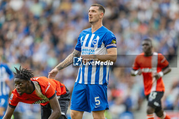 2023-08-12 - Brighton & Hove Albion defender Lewis Dunk during the English championship Premier League football match between Brighton and Hove Albion and Luton Town on 12 August 2023 at the American Express Community Stadium in Brighton and Hove, England - FOOTBALL - ENGLISH CHAMP - BRIGHTON V LUTON TOWN - ENGLISH PREMIER LEAGUE - SOCCER