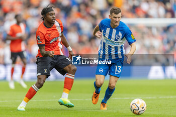 2023-08-12 - Luton Town midfielder Pelly Ruddock Mpanzu (17) and Brighton & Hove Albion midfielder Pascal Gross (13) during the English championship Premier League football match between Brighton and Hove Albion and Luton Town on 12 August 2023 at the American Express Community Stadium in Brighton and Hove, England - FOOTBALL - ENGLISH CHAMP - BRIGHTON V LUTON TOWN - ENGLISH PREMIER LEAGUE - SOCCER