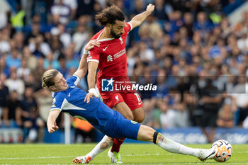 2023-08-13 - Chelsea midfielder Conor Gallagher (23) tackles Liverpool forward Mohamed Salah (11) during the English championship Premier League football match between Chelsea and Liverpool on 13 August 2023 at Stamford Bridge in London, England - FOOTBALL - ENGLISH CHAMP - CHELSEA V LIVERPOOL - ENGLISH PREMIER LEAGUE - SOCCER