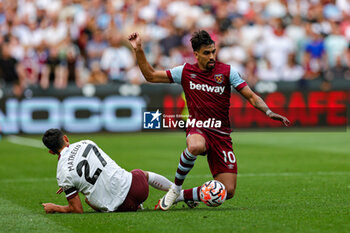 2023-09-16 - Matheus Nunes (27) of Manchester City slides in and tackles Lucas Paqueta (10) of West Ham during the Premier League match between West Ham United and Manchester City at the London Stadium, London, England on 16 September 2023. Photo Nigel Keene/ProSportsImages / DPPI - FOOTBALL - ENGLISH CHAMP - WEST HAM V MANCHESTER CITY - ENGLISH PREMIER LEAGUE - SOCCER
