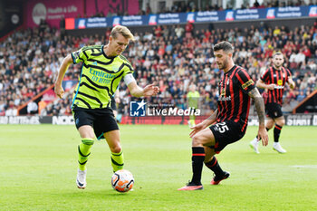 2023-09-30 - Martin Odegaard (8) of Arsenal and Marcos Senesi (25) of AFC Bournemouth during the English championship Premier League football match between Bournemouth and Arsenal on 30 September 2023 at the Vitality Stadium in Bournemouth, England - FOOTBALL - ENGLISH CHAMP - BOURNEMOUTH V ARSENAL - ENGLISH PREMIER LEAGUE - SOCCER