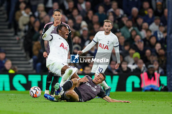 2023-10-23 - Joao Palhinha (26) of Fulham slides in and tackles Destiny Udogie (38) of Tottenham during the English championship Premier League football match between Tottenham Hotspur and Fulham on 23 October 2023 at Tottenham Hotspur Stadium in London, England - FOOTBALL - ENGLISH CHAMP - TOTTENHAM V FULHAM - ENGLISH PREMIER LEAGUE - SOCCER