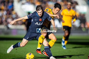 2023-11-11 - Wolverhampton Wanderers forward Hwang Hee-Chan (11) battles for possession with Tottenham Hotspur defender Ben Davies (33) during the English championship Premier League football match between Wolverhampton Wanderers and Tottenham Hotspur on 11 November 2023 at Molineux in Wolverhampton, England - FOOTBALL - ENGLISH CHAMP - WOLVERHAMPTON V TOTTENHAM - ENGLISH PREMIER LEAGUE - SOCCER