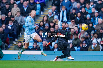 2023-11-25 - Liverpool goalkeeper Alisson Becker (1) clears away from Manchester City forward Erling Haaland (9) during the English championship Premier League football match between Manchester City and Liverpool on 25 November 2023 at the Etihad Stadium in Manchester, England - FOOTBALL - ENGLISH CHAMP - MANCHESTER CITY V LIVERPOOL - ENGLISH PREMIER LEAGUE - SOCCER