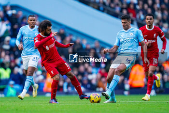 2023-11-25 - Liverpool forward Mohamed Salah (11) takes on Manchester City midfielder Rodri (16) during the English championship Premier League football match between Manchester City and Liverpool on 25 November 2023 at the Etihad Stadium in Manchester, England - FOOTBALL - ENGLISH CHAMP - MANCHESTER CITY V LIVERPOOL - ENGLISH PREMIER LEAGUE - SOCCER