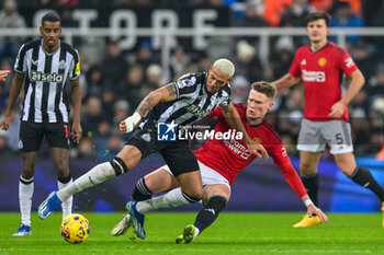 2023-12-02 - Scott McTominay of Manchester United tackles Joelinton of Newcastle during the English championship Premier League football match between Newcastle United and Manchester United on 2 December 2023 at St James’ Park in Newcastle, England - FOOTBALL - ENGLISH CHAMP - NEWCASTLE V MANCHESTER UNITED - ENGLISH PREMIER LEAGUE - SOCCER