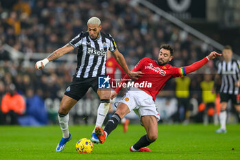 2023-12-02 - Bruno Fernandes of Manchester United tackles Joelinton of Newcastle during the English championship Premier League football match between Newcastle United and Manchester United on 2 December 2023 at St James’ Park in Newcastle, England - FOOTBALL - ENGLISH CHAMP - NEWCASTLE V MANCHESTER UNITED - ENGLISH PREMIER LEAGUE - SOCCER