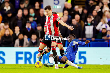 2023-12-18 - Benoit Badiashile (5) of Chelsea slides in and tackles Anel Ahmedhodzic (15) of Sheffield during the English championship Premier League football match between Chelsea and Sheffield United on 16 December 2023 at Stamford Bridge in London, England - FOOTBALL - ENGLISH CHAMP - CHELSEA V SHEFFIELD UNITED - ENGLISH PREMIER LEAGUE - SOCCER