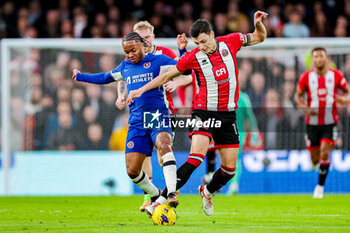 2023-12-18 - Raheem Sterling (7) of Chelsea tussles with Anel Ahmedhodzic (15) of Sheffield during the English championship Premier League football match between Chelsea and Sheffield United on 16 December 2023 at Stamford Bridge in London, England - FOOTBALL - ENGLISH CHAMP - CHELSEA V SHEFFIELD UNITED - ENGLISH PREMIER LEAGUE - SOCCER