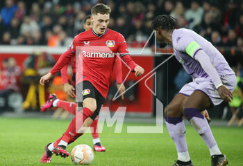 2023-02-16 - Florian Wirtz of Bayer Leverkusen and Axel Disasi of AS Monaco during the UEFA Europa League, Play-off, 1st leg football match between Bayer Leverkusen and AS Monaco on February 16, 2023 at BayArena in Leverkusen, Germany - FOOTBALL - EUROPA LEAGUE - LEVERKUSEN V MONACO - UEFA EUROPA LEAGUE - SOCCER