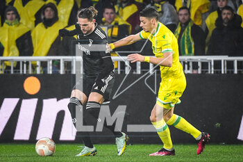 2023-02-23 - Adrien RABIOT of Juventus and Andrei GIROTTO of Nantes during the UEFA Europa League, Play-off, 2nd leg football match between FC Nantes and Juventus FC on February 23, 2023 at La Beaujoire stadium in Nantes, France - FOOTBALL - EUROPA LEAGUE - NANTES V JUVENTUS - UEFA EUROPA LEAGUE - SOCCER