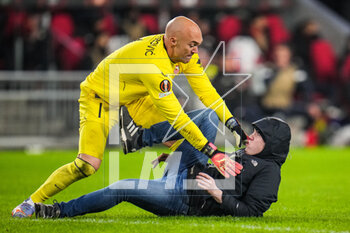 2023-02-23 - Marko Dmitrovic of Sevilla FC fights with a supporter who invaded the pitch during the UEFA Europa League, Play-off, 2nd leg football match between PSV and Sevilla FC on February 23, 2023 at the Philips Stadion in Eindhoven, Netherlands - FOOTBALL - EUROPA LEAGUE - PSV V SEVILLA FC - UEFA EUROPA LEAGUE - SOCCER