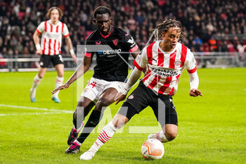 2023-02-23 - Tanguy Nianzou of Sevilla FC challenges Xavi Simons of PSV during the UEFA Europa League, Play-off, 2nd leg football match between PSV and Sevilla FC on February 23, 2023 at the Philips Stadion in Eindhoven, Netherlands - FOOTBALL - EUROPA LEAGUE - PSV V SEVILLA FC - UEFA EUROPA LEAGUE - SOCCER