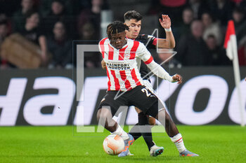 2023-02-23 - Johan Bakayoko of PSV is challenged by Marcos Acuna of Sevilla FC during the UEFA Europa League, Play-off, 2nd leg football match between PSV and Sevilla FC on February 23, 2023 at the Philips Stadion in Eindhoven, Netherlands - FOOTBALL - EUROPA LEAGUE - PSV V SEVILLA FC - UEFA EUROPA LEAGUE - SOCCER