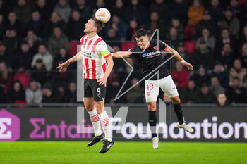 2023-02-23 - Luuk de Jong of PSV and Marcos Acuna of Sevilla FC during the UEFA Europa League, Play-off, 2nd leg football match between PSV and Sevilla FC on February 23, 2023 at the Philips Stadion in Eindhoven, Netherlands - FOOTBALL - EUROPA LEAGUE - PSV V SEVILLA FC - UEFA EUROPA LEAGUE - SOCCER
