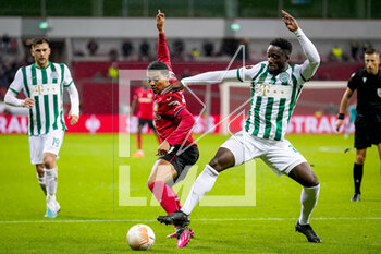 2023-03-09 - Amine Adli of Bayer 04 Leverkusen is challenged by Myenty Abena of Ferencvaros during the UEFA Europa League, Round of 16, 1st leg football match between Bayer 04 Leverkusen and Ferencvaros TC on March 9, 2023 at the BayArena in Leverkusen, Germany - FOOTBALL - EUROPA LEAGUE - LEVERKUSEN V FERENCVAROS - UEFA EUROPA LEAGUE - SOCCER