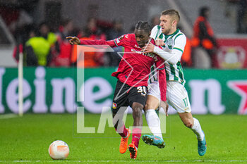 2023-03-09 - Jeremie Frimpong of Bayer 04 Leverkusen, Eldar Civic of Ferencvaros during the UEFA Europa League, Round of 16, 1st leg football match between Bayer 04 Leverkusen and Ferencvaros TC on March 9, 2023 at the BayArena in Leverkusen, Germany - FOOTBALL - EUROPA LEAGUE - LEVERKUSEN V FERENCVAROS - UEFA EUROPA LEAGUE - SOCCER