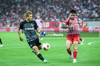 2023-09-21 - 42 Ritsu Doan of SC Freiburg competing with 3 Francisco Ortega of Olympiacos FC during the Europa League Group A match between Olympiacos FC and SC Freiburg at Georgios Karaiskakis Stadium on September 21, 2023, in Athens, Greece. - OLYMPIACOS VS FREIBURG, EUROPA LEAGUE, GROUP A - UEFA EUROPA LEAGUE - SOCCER
