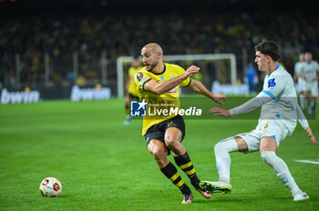 2023-11-09 - 5 Nordin Amrabat of AEK FC competing with 5 Leonardo Balerdi of Marseille during the UEFA Europa League, Group B match between AEK FC and Marseille at Opap Arena on November 9, 2023, in Athens, Greece. - AEK FC VS MARSEILLE - UEFA EUROPA LEAGUE, GROUP B - UEFA EUROPA LEAGUE - SOCCER