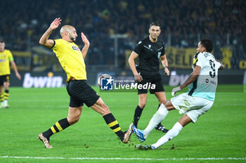 2023-11-30 - 5 Nordin Amrabat of AEK FC competing with 9 Joao Pedro of Brighton & Hove Albion during the UEFA Europa League, Group B match between AEK FC and Brighton & Hove Albion at Opap Arena on November 30, 2023, in Athens, Greece. - AEK FC VS BRIGHTON - UEFA EUROPA LEAGUE, GROUP B - UEFA EUROPA LEAGUE - SOCCER