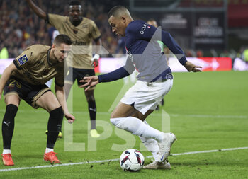 2023-01-01 - Kylian Mbappe of PSG, Przemyslaw Frankowski of Lens (left) during the French championship Ligue 1 football match between RC Lens and Paris Saint-Germain on January 1, 2023 at Bollaert-Delelis stadium in Lens, France - FOOTBALL - FRENCH CHAMP - LENS V PARIS SG - FRENCH LIGUE 1 - SOCCER