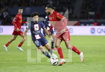2023-01-11 - Sofiane Boufal of Angers, Warren Zaire-Emery of PSG (left) during the French championship Ligue 1 football match between Paris Saint-Germain (PSG) and SCO Angers on January 11, 2023 at Parc des Princes stadium in Paris, France - FOOTBALL - FRENCH CHAMP - PARIS SG V ANGERS - FRENCH LIGUE 1 - SOCCER