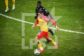 2023-01-14 - Facundo Axel MEDINA of Lens and Rayan RAVELOSON of Auxerre during the French championship Ligue 1 football match between RC Lens and AJ Auxerre on January 14, 2023 at Bollaert-Delelis stadium in Lens, France - FOOTBALL - FRENCH CHAMP - LENS V AUXERRE - FRENCH LIGUE 1 - SOCCER