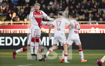2023-02-11 - Aleksandr Golovin of Monaco #17 celebrates his goal with Caio Henrique (left), Wissam Ben Yedder of Monaco during the French championship Ligue 1 football match between AS Monaco (ASM) and Paris Saint-Germain (PSG) on February 11, 2023 at Stade Louis II in Monaco - FOOTBALL - FRENCH CHAMP - MONACO V PARIS SG - FRENCH LIGUE 1 - SOCCER