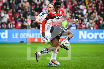 2023-02-12 - Lucas PERRIN of Strasbourg and Jonathan DAVID of Lille during the French championship Ligue 1 football match between Losc Lille and RC Strasbourg on February 12, 2023 at Pierre Mauroy stadium in Villeneuve-d'Ascq near Lille, France - FOOTBALL - FRENCH CHAMP - LILLE V STRASBOURG - FRENCH LIGUE 1 - SOCCER