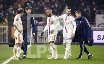2023-02-12 - Injured, Alexandre Lacazette of Lyon - here comforted by Corentin Tolisso of Lyon - leaves the pitch during the French championship Ligue 1 football match between Olympique Lyonnais (OL) and RC Lens (RCL) on February 12, 2023 at Groupama stadium in Decines-Charpieu near Lyon, France - FOOTBALL - FRENCH CHAMP - LYON V LENS - FRENCH LIGUE 1 - SOCCER